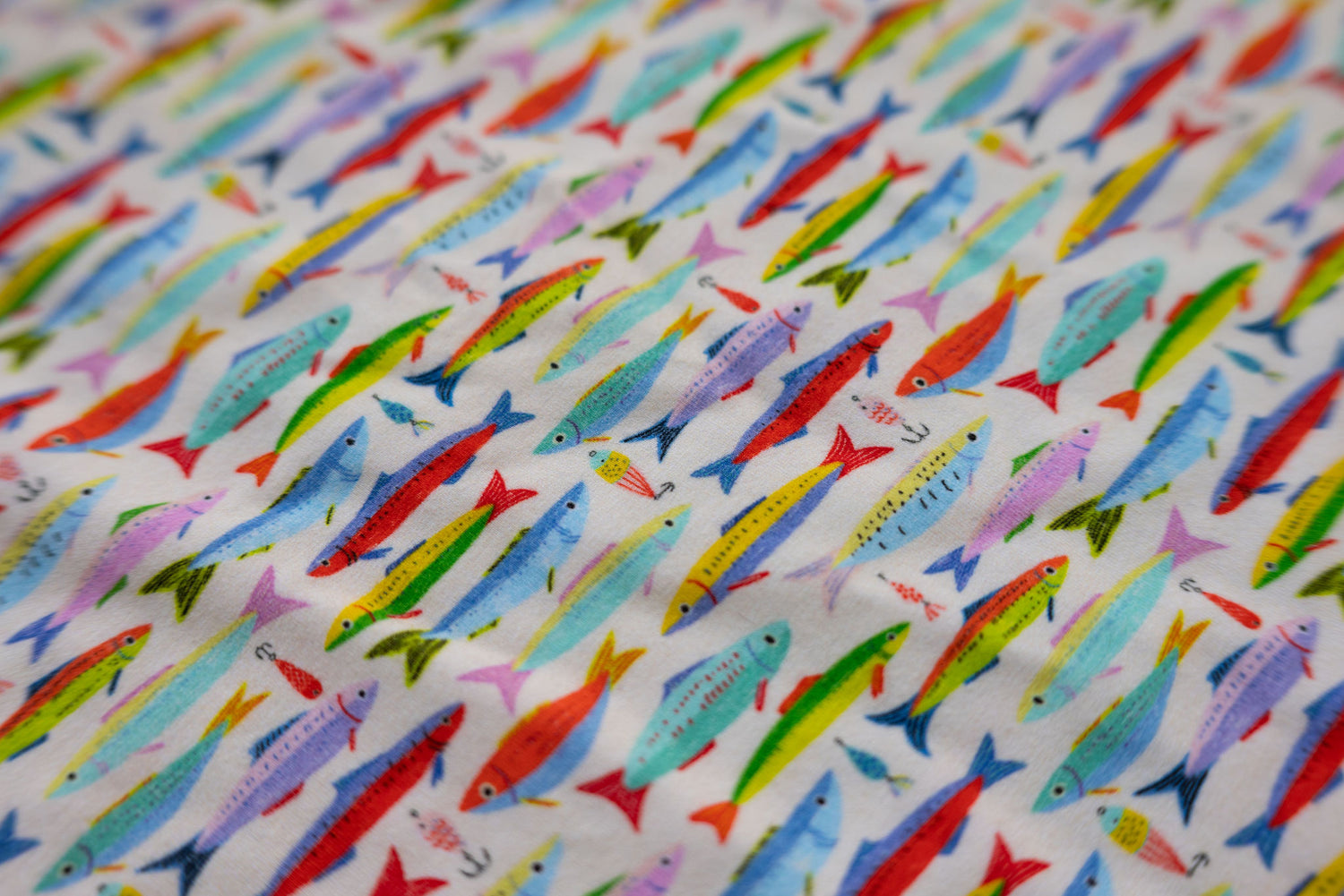 A playful, coastal-inspired print featuring hand-drawn fish and vintage fishing lures in a lively mix of sun-washed colors.