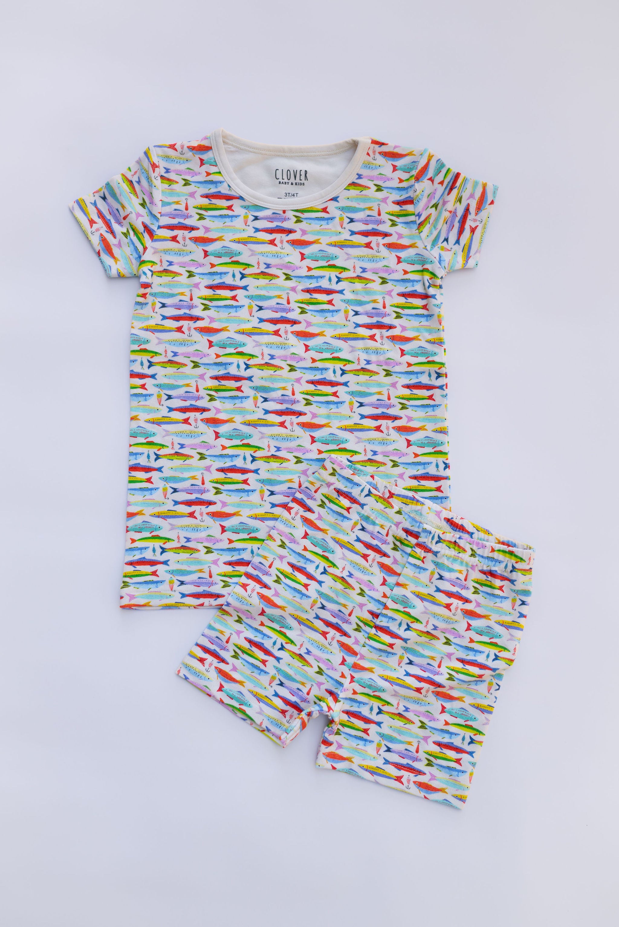 A playful, coastal-inspired print featuring hand-drawn fish and vintage fishing lures in a lively mix of sun-washed colors.